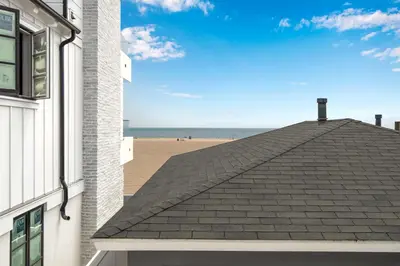 a roof of a building with the beach in the background at TWO BEACHFRONT BUNGALOWS ON THE SAND IN Newport Beach in Newport Beach