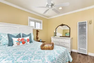 a bedroom with a bed and a ceiling fan at TWO BEACHFRONT BUNGALOWS ON THE SAND IN Newport Beach in Newport Beach