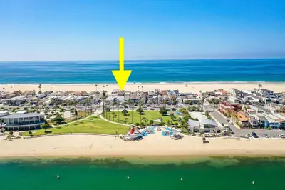 an aerial view of a beach with a yellow arrow at Luxury 4 Bedroom Oceanfront Home with AC in Newport Beach