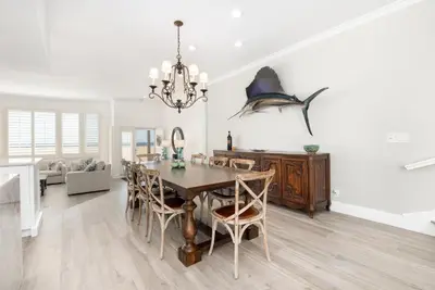 a dining room with a table and a shark on the wall at Luxury 4 Bedroom Oceanfront Home with AC in Newport Beach