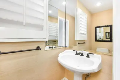 a bathroom with a white sink and a mirror at Luxury 4 Bedroom Oceanfront Home with AC in Newport Beach