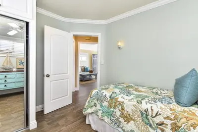 a bedroom with a bed with a blue pillow on it at Oceanfront Back Home with View of the Sea in Newport Beach