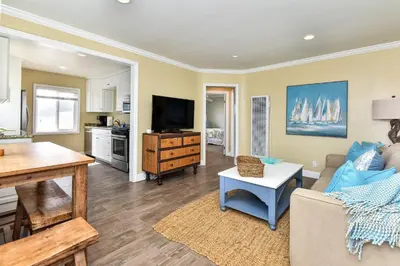 a living room with a couch and a tv at Oceanfront Back Home with View of the Sea in Newport Beach