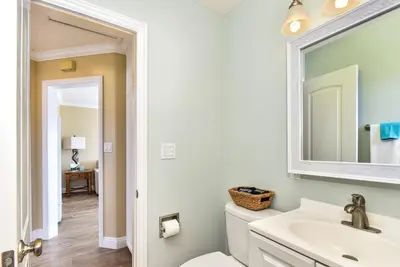 a bathroom with a sink and a toilet and a mirror at Oceanfront Back Home with View of the Sea in Newport Beach