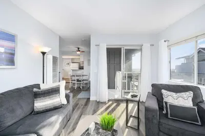 a living room with a couch and a table at 5 Bedroom Duplex on the Boardwalk next to Balboa Pier in Newport Beach