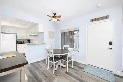 a kitchen and dining room with a table and chairs at 1 Bedroom Apartment in the back of our Oceanfront Home in Newport Beach