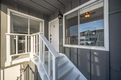 a house with a white staircase and a window at 1 Bedroom Apartment in the back of our Oceanfront Home in Newport Beach