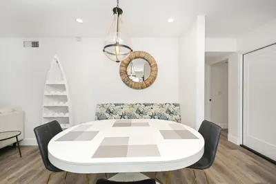 a white dining room with a white table and chairs at Perfect Renovated and Modern Duplex on Balboa Island in Newport Beach