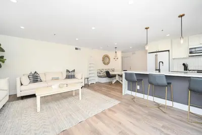 a kitchen and living room with a couch and a table at Perfect Renovated and Modern Duplex on Balboa Island in Newport Beach