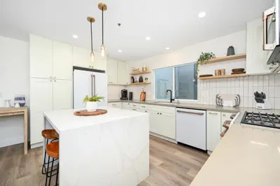 a kitchen with white cabinets and a white counter top at Perfect Renovated and Modern Duplex on Balboa Island in Newport Beach