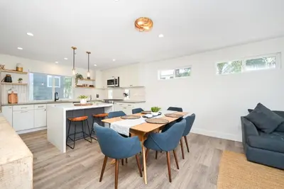 a kitchen and dining room with a table and chairs at 4 bedroom Renovated Home on Balboa Island in Newport Beach