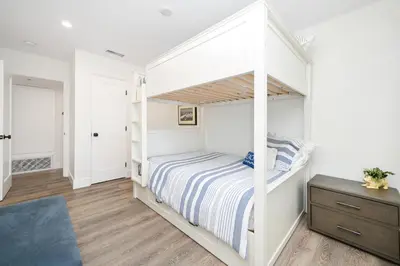 a bedroom with a white bunk bed at 4 bedroom Renovated Home on Balboa Island in Newport Beach