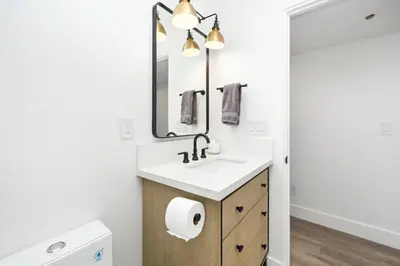 a bathroom with a sink and a mirror at 4 bedroom Renovated Home on Balboa Island in Newport Beach