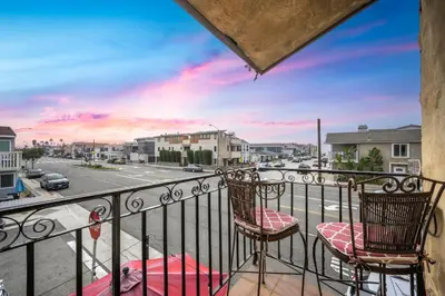 two chairs on a balcony with a view of a street at Spanish Castle By The Sea in Newport Beach in Newport Beach