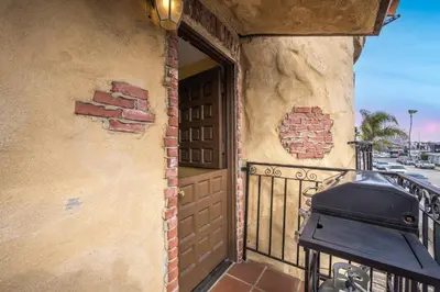 a front door of a house with a grill on a balcony at Spanish Castle By The Sea in Newport Beach in Newport Beach