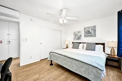 a bedroom with a bed and a ceiling fan at Charming 1-Bedroom Home on 29th Street in Newport Beach