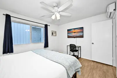 a bedroom with a bed and a ceiling fan at Charming 1-Bedroom Home on 29th Street in Newport Beach