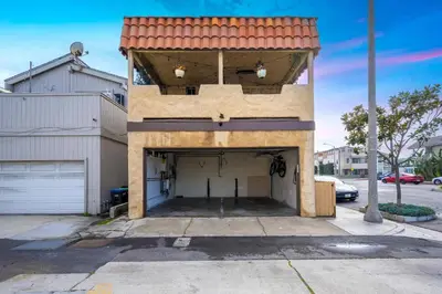 a building with a garage with a roof at Charming 1-Bedroom Home on 29th Street in Newport Beach