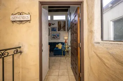 a hallway of a house with a sign on the door at Spanish Castle in Newport Steps to the Sand and Grocery Store in Newport Beach