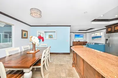 a kitchen and dining room with a wooden table at 3 Bedroom Luxury Home Steps to Balboa Fun Zone in Newport Beach