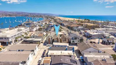 an aerial view of a city with a blue arrow at 3 Bedroom Luxury Home Steps to Balboa Fun Zone in Newport Beach
