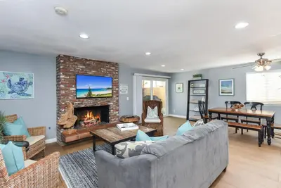 a living room with a couch and a fireplace at 2 Bed 2 Bath Jacuzzi Home with Parking on 51st St in Newport Beach