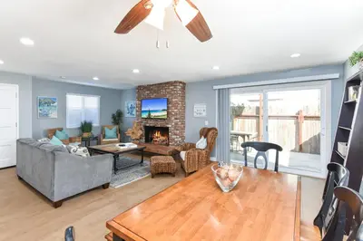 a living room with a couch and a fireplace at 2 Bed 2 Bath Jacuzzi Home with Parking on 51st St in Newport Beach