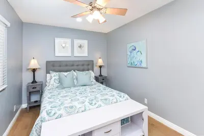 a bedroom with a bed and a ceiling fan at 2 Bed 2 Bath Jacuzzi Home with Parking on 51st St in Newport Beach