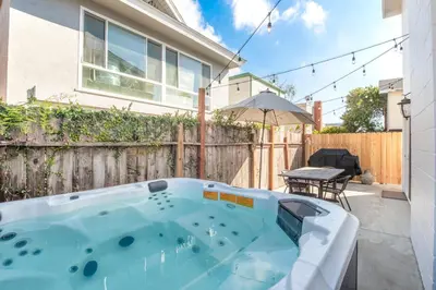 a hot tub in the backyard of a house at 2 Bed 2 Bath Jacuzzi Home with Parking on 51st St in Newport Beach