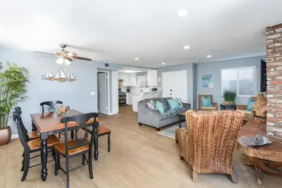 a living room with a table and a couch at 2 Bed 2 Bath Jacuzzi Home with Parking on 51st St in Newport Beach