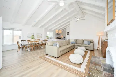 a living room with a couch and a table at Great Location near the Balboa Pier and Fun Zone with Air conditioning in Newport Beach