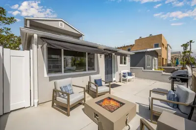 a patio with chairs and a fire pit at Remodeled 4 Car with Parking Patio and Firepit in Newport Beach