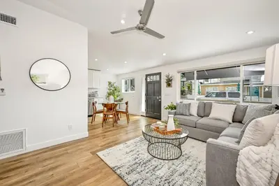 a living room with a couch and a table at Remodeled Beach Home with 2 Car Parking Patio and Firepit in Newport Beach