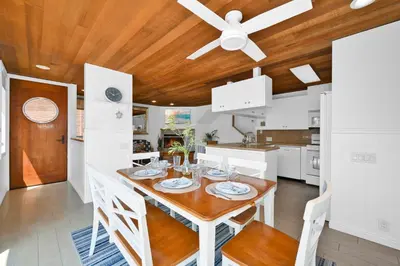a dining room with a table and a ceiling fan at 4 bedroom Home in Quiet Neighborhood near Beach in Newport Beach