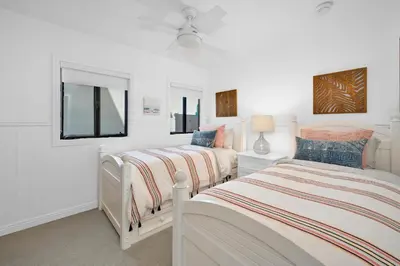 two beds in a bedroom with white walls at 4 bedroom Home in Quiet Neighborhood near Beach in Newport Beach