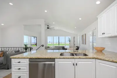 a kitchen with two sinks and a living room at 3 Bedroom with Park and Beach in your Backyard! in Newport Beach