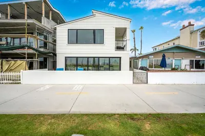 a white house with a white wall at 3 Bedroom with Park and Beach in your Backyard! in Newport Beach