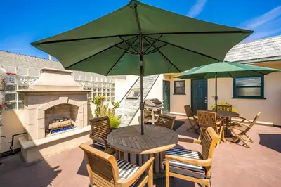 a patio with a table and chairs with a fireplace at 514 E Oceanfront B in Newport Beach