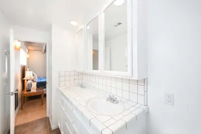 a bathroom with a sink and a mirror at Single Family Home on the Ocean with BEAUTIFUL VIEWS in Newport Beach