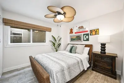 a bedroom with a bed and a ceiling fan at Single Family Home on the Ocean with BEAUTIFUL VIEWS in Newport Beach