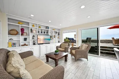a living room with a couch and chairs and a tv at Single Family Home on the Ocean with BEAUTIFUL VIEWS in Newport Beach