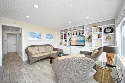 a living room with a couch and a tv at Single Family Home on the Ocean with BEAUTIFUL VIEWS in Newport Beach