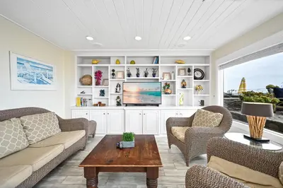 a living room with a couch and chairs and a tv at Single Family Home on the Ocean with BEAUTIFUL VIEWS in Newport Beach