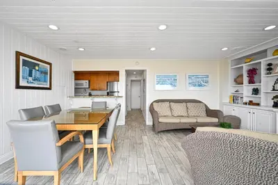 a dining room and living room with a table and chairs at Single Family Home on the Ocean with BEAUTIFUL VIEWS in Newport Beach