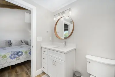 a white bathroom with a sink and a mirror at Brand New Modern Home by the Beach with Patio & BBQ in Newport Beach
