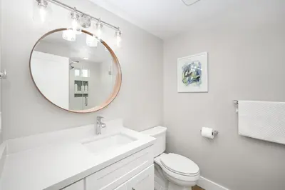 a white bathroom with a sink and a mirror at Brand New Modern Home by the Beach with Patio & BBQ in Newport Beach