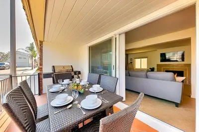 a dining table and chairs in a living room at 2 Story Home with Garage 1 Block to the Beach wi in Newport Beach