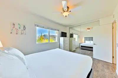 a bedroom with a bed and a ceiling fan at 2 Story Home with Garage 1 Block to the Beach wi in Newport Beach
