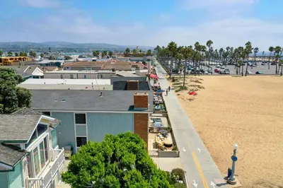 an aerial view of a town with a beach and buildings at 7 Bedroom Oceanfront Triplex Building in Newport Beach