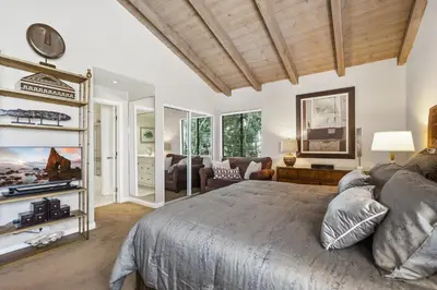 a bedroom with a large bed and a living room at 2 Bed 2 Bath BACK APT Steps to the Sand in Newport Beach